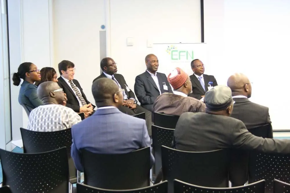Guests listen to a panel beside an EFN banner at the 11th Annual Spring Event in London.
